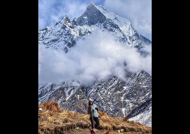 Standing in front of Machapuchare, a sacred Nepalese mountain that has never been summited